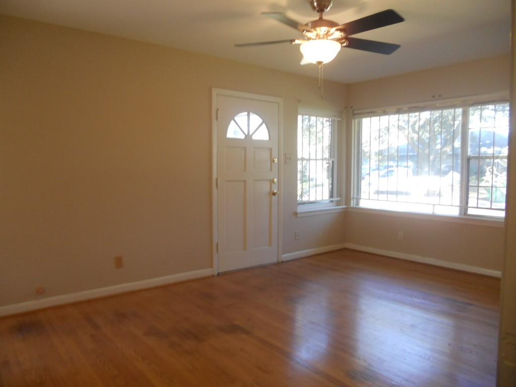4709 Sanford Road Houston, TX 77035 - Photo 4 of 19 wooden floor in an empty room with a window