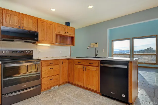 a kitchen with granite countertop a sink and cabinets