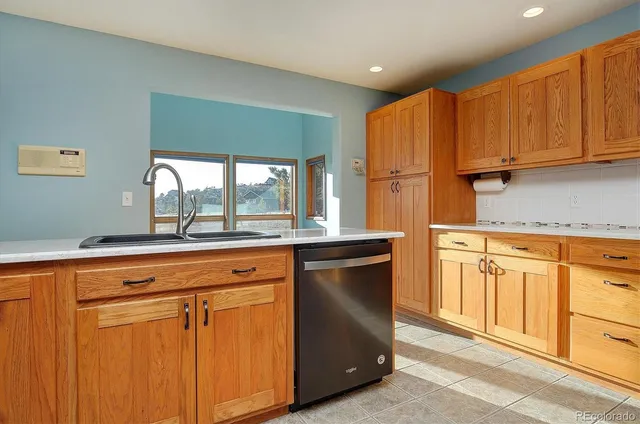 a kitchen with stainless steel appliances granite countertop a refrigerator sink and cabinets
