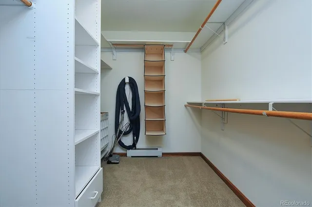 a view of walk in closet with clothes