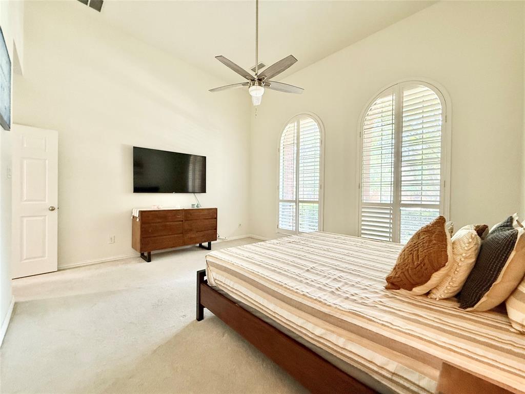 2754 Ridge View Road Frisco, TX 75034 - Photo 15 of 34 a bedroom with a bed and a flat screen tv