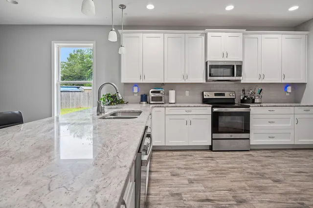 a bedroom with a bed dresser and a window