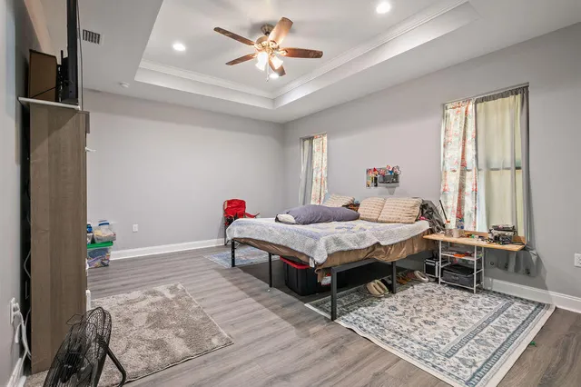 a bedroom with a bed and a chandelier