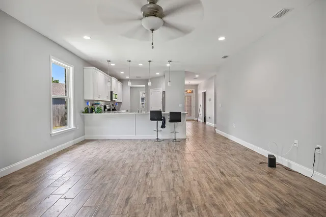 wooden floor in an empty room with a window