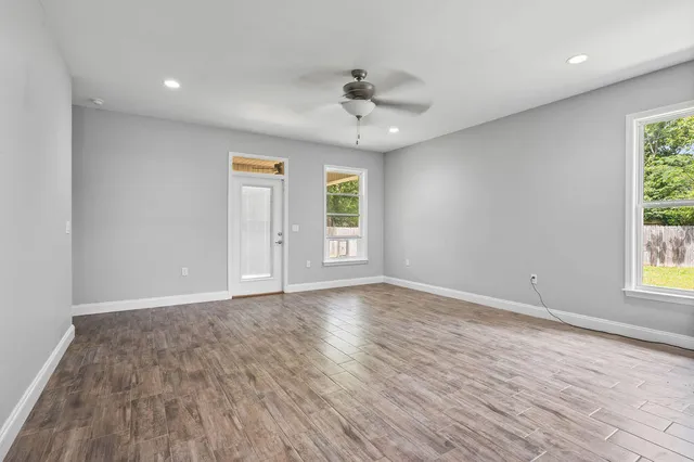 a kitchen with stainless steel appliances granite countertop a sink a stove and a refrigerator