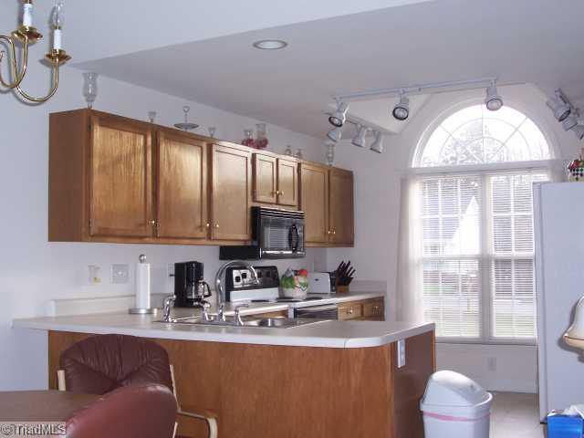 1110 Woodbury Road King, NC 27021 - Photo 4 of 11 Kitchen. You ll love to prepare dinner in this bright kitchen! Eat at the bar if you like. Stove, dishwasher and refrigerator are to remain.