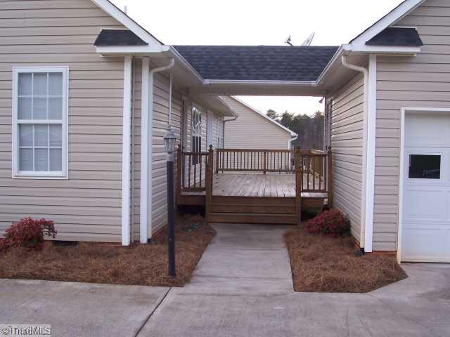 1110 Woodbury Road King, NC 27021 - Photo 8 of 11 Other. Breezeway connects double garage to home. Also shows the back deck.
