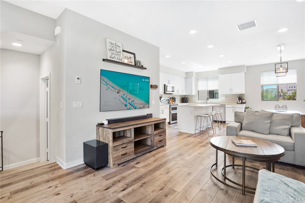 237 Magnet Irvine, CA 92618 - Photo 3 of 22 a living room with furniture a flat screen tv and kitchen view