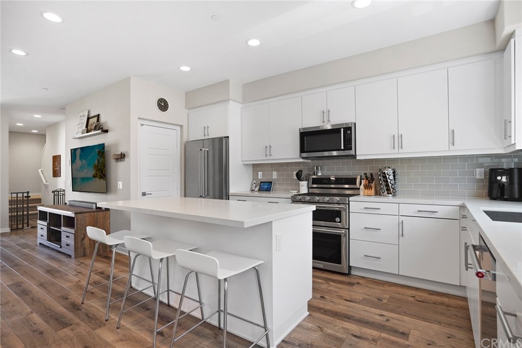 237 Magnet Irvine, CA 92618 - Photo 6 of 22 a kitchen with granite countertop white cabinets and stainless steel appliances