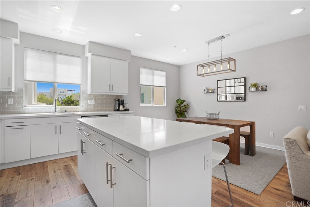 237 Magnet Irvine, CA 92618 - Photo 7 of 22 a kitchen with a table chairs cabinets and window