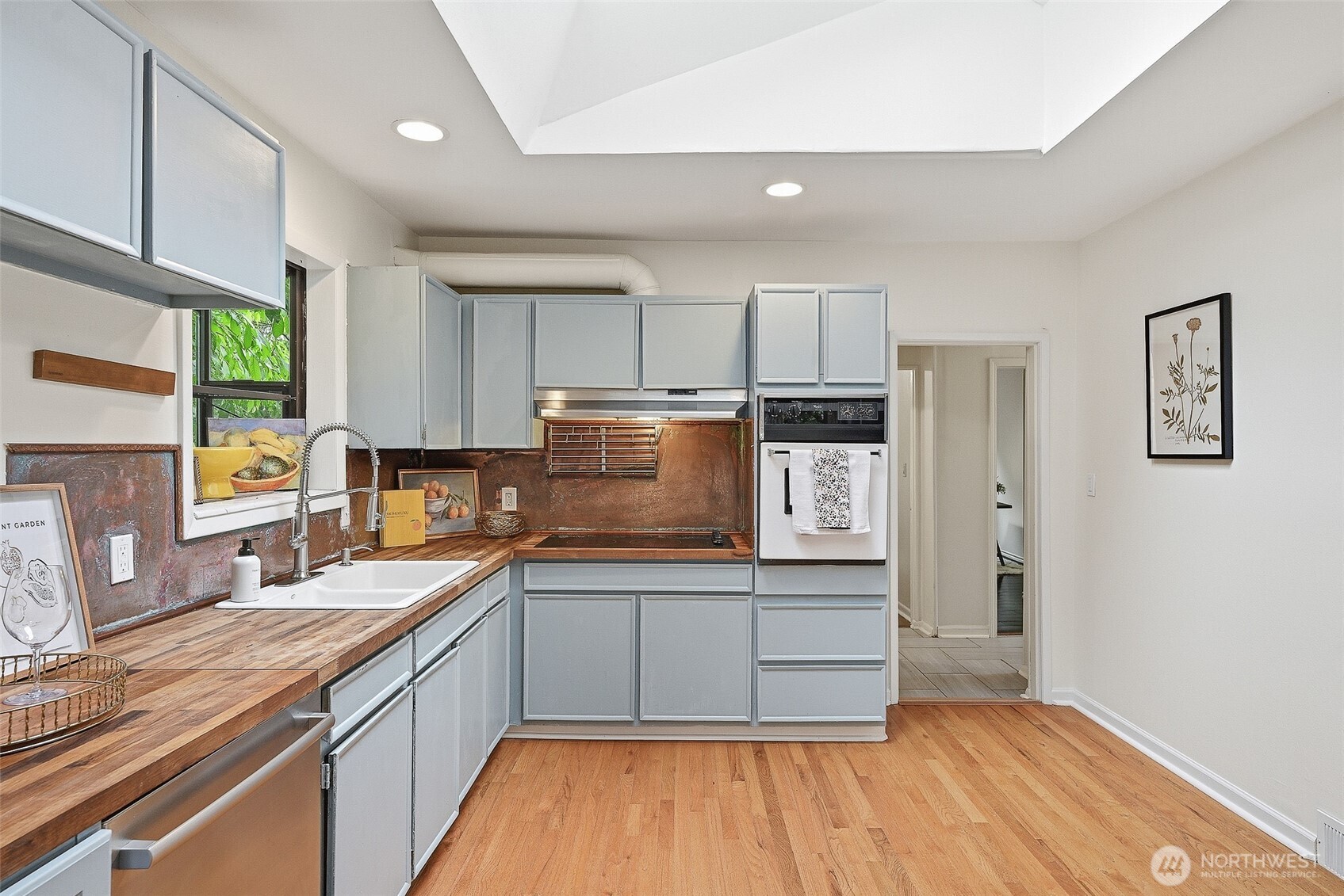 17633 10th Avenue Northeast Shoreline, WA 98155 - Photo 13 of 33 a kitchen with stainless steel appliances granite countertop a stove a sink and a refrigerator