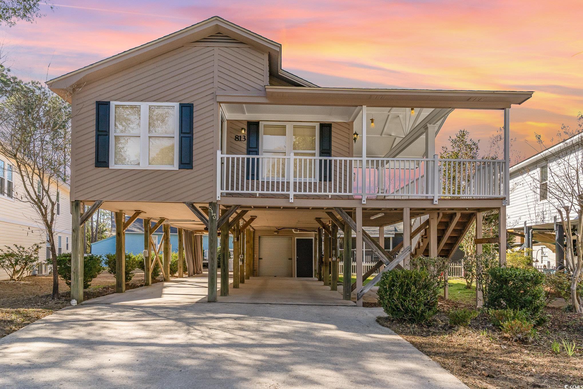 813 Starboard Court Murrells Inlet, SC 29576 - Photo 1 of 17 Beach home featuring covered porch, stairway, a ca