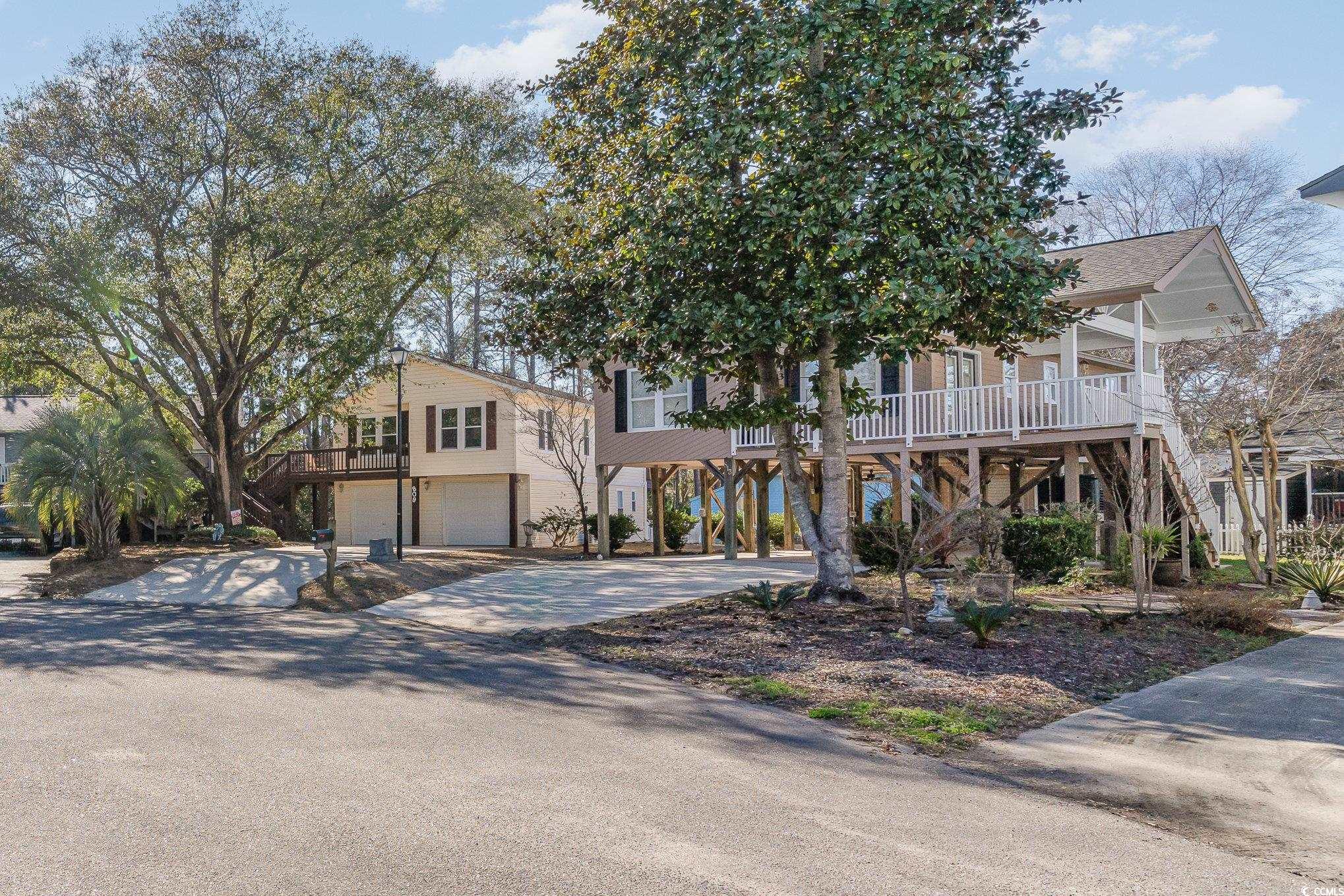 813 Starboard Court Murrells Inlet, SC 29576 - Photo 15 of 17 Coastal home with a porch, driveway, stairway, and