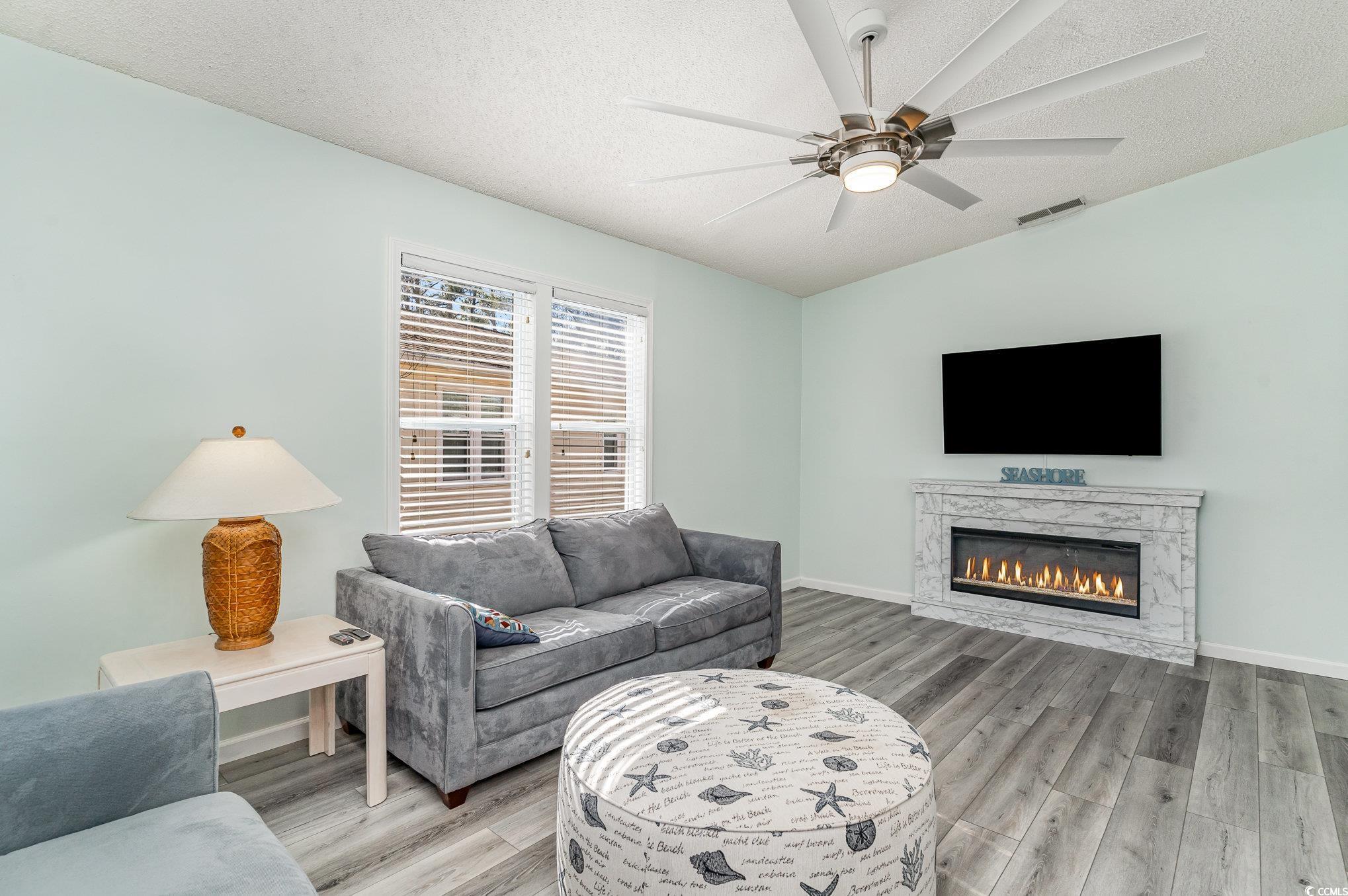 813 Starboard Court Murrells Inlet, SC 29576 - Photo 2 of 17 Living area featuring a textured ceiling, light wo