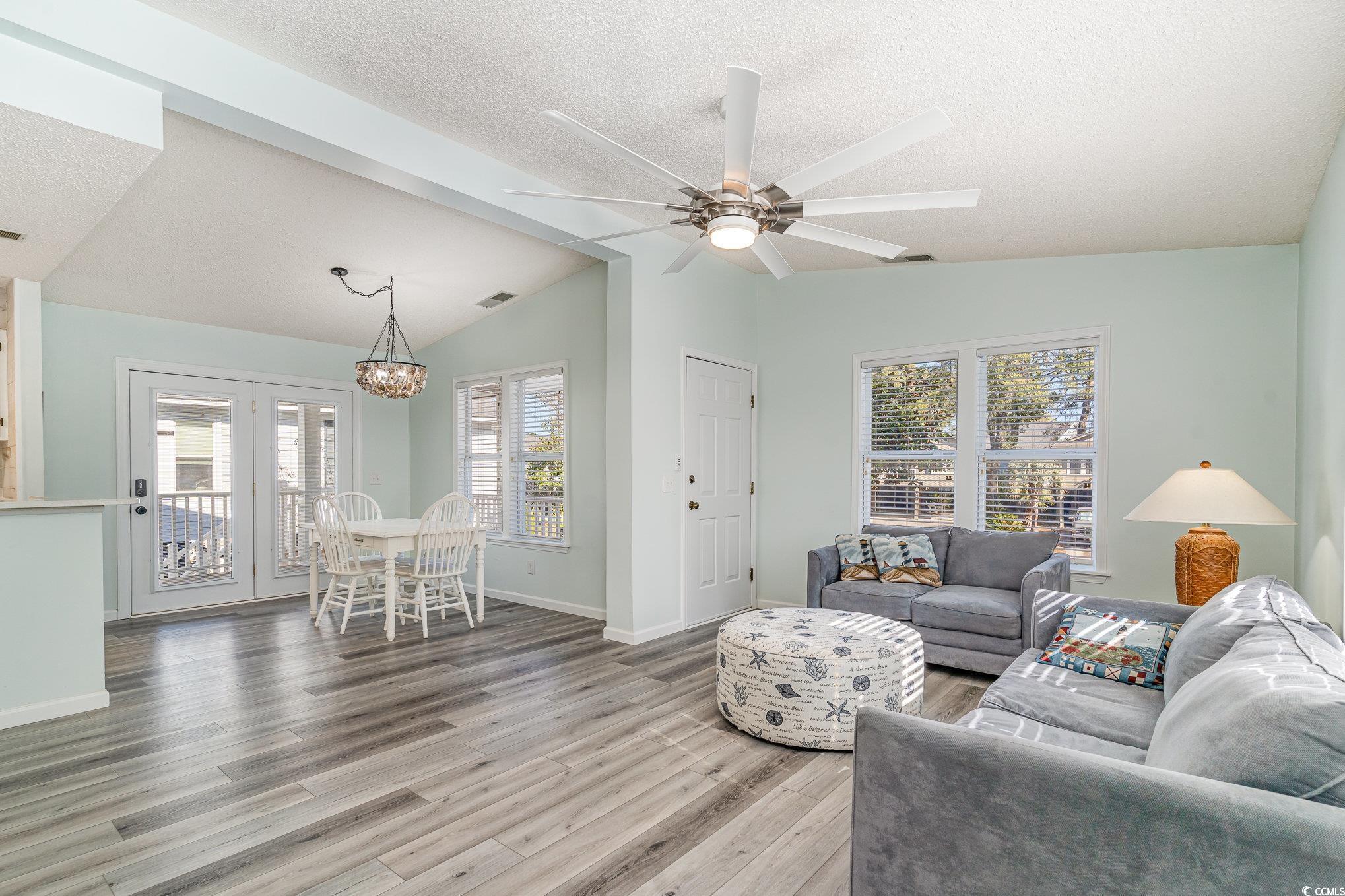 813 Starboard Court Murrells Inlet, SC 29576 - Photo 3 of 17 Living area featuring lofted ceiling, a textured c