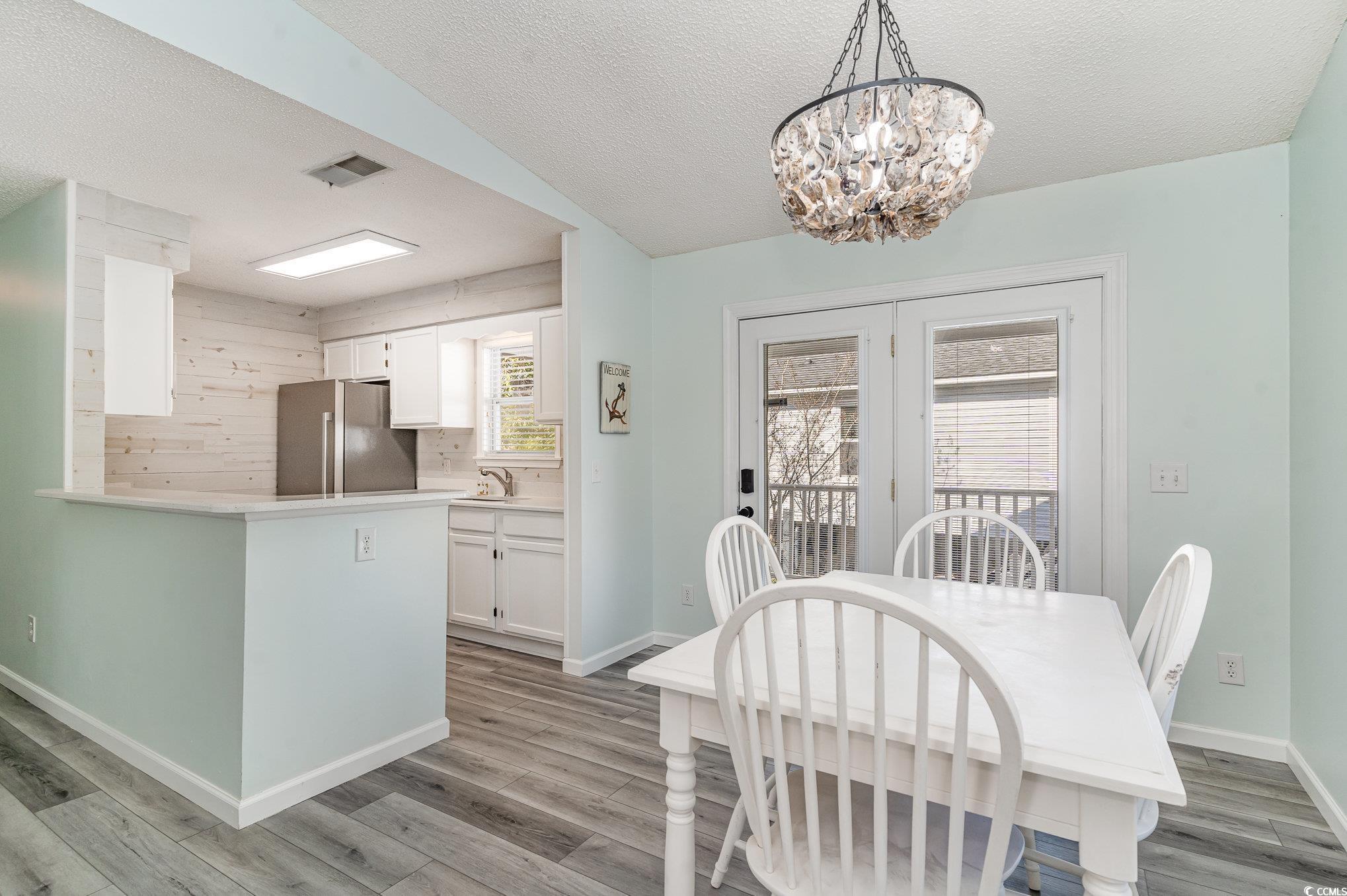 813 Starboard Court Murrells Inlet, SC 29576 - Photo 4 of 17 Dining area with visible vents, light wood-style f