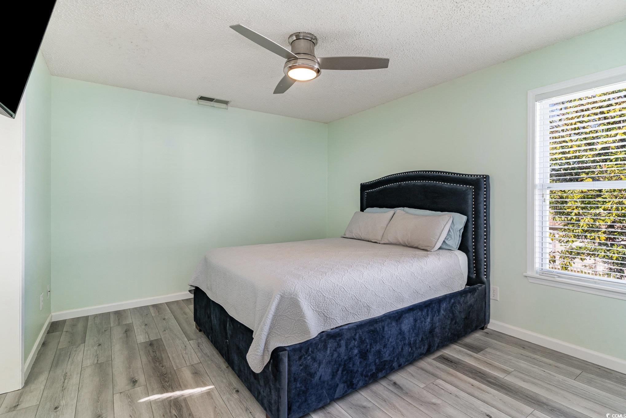 813 Starboard Court Murrells Inlet, SC 29576 - Photo 6 of 17 Bedroom with wood finished floors, visible vents,