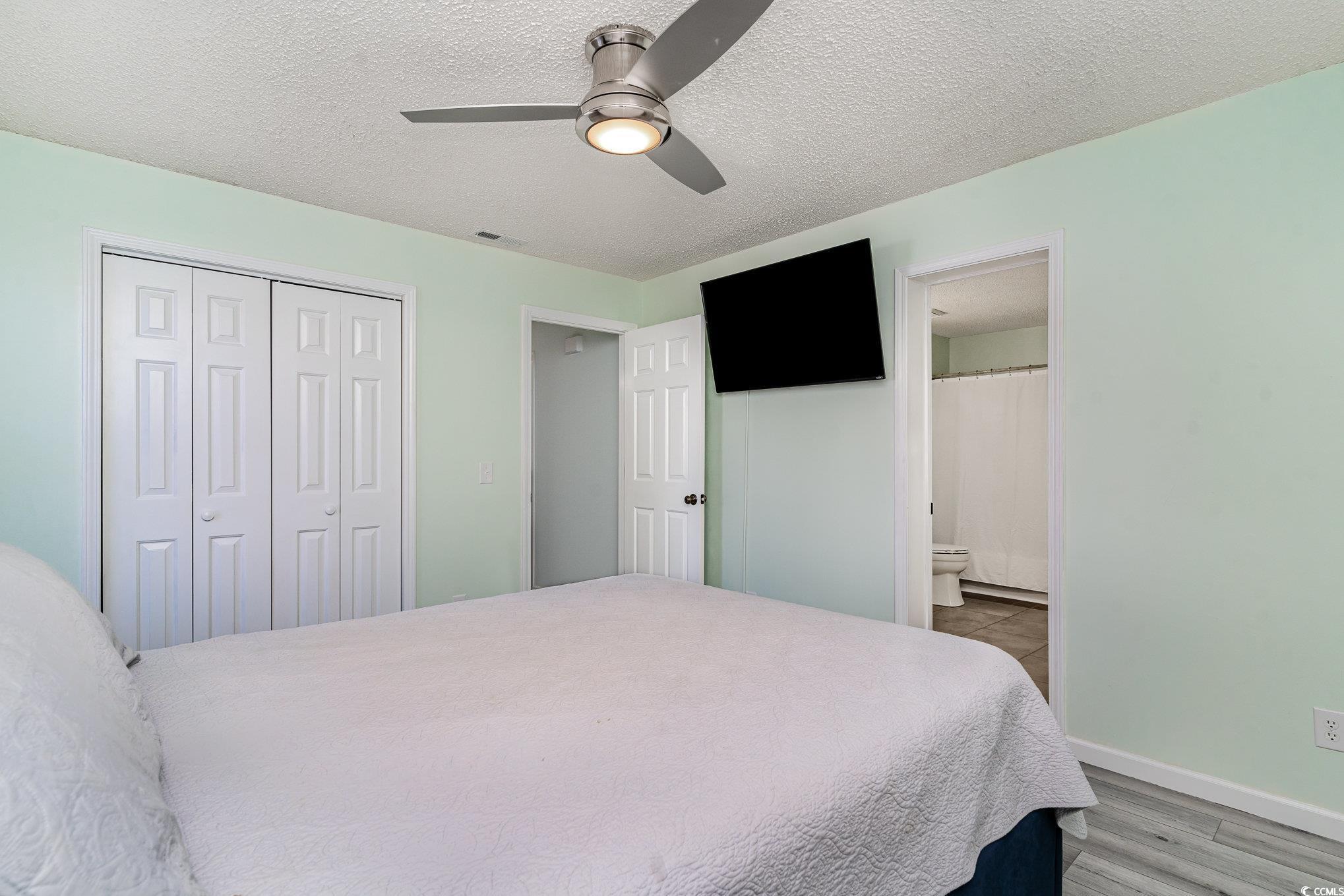 813 Starboard Court Murrells Inlet, SC 29576 - Photo 7 of 17 Bedroom with a ceiling fan, a closet, a textured c