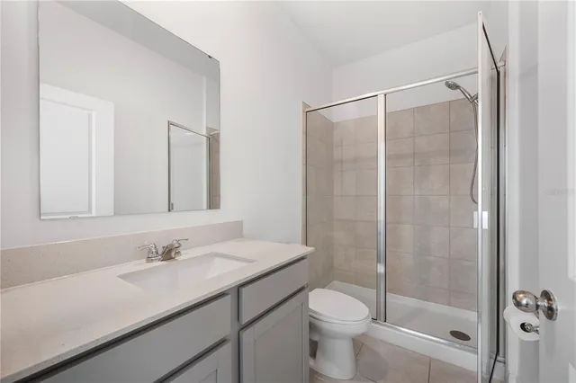 a bathroom with a shower a toilet and a sink