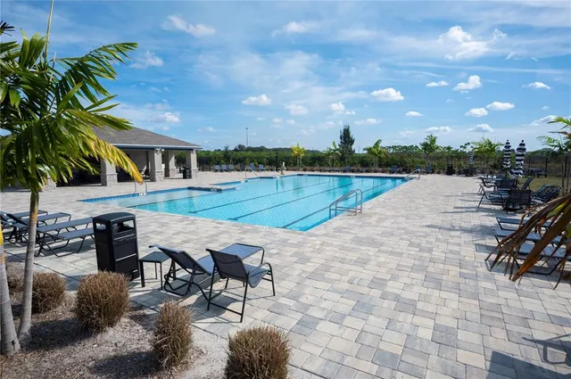 a view of a swimming pool with lounge chairs