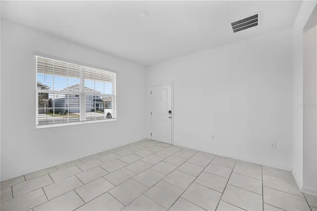 a kitchen with a sink a refrigerator and cabinets