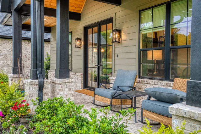 a view of a patio with table and chairs and potted plants