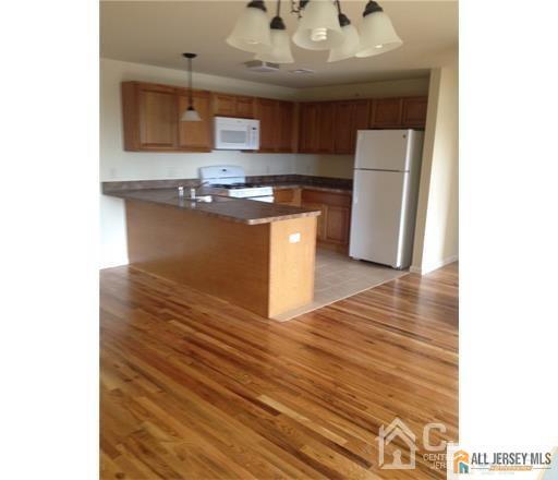 95 Main Street Sayreville, NJ 08872 - Photo 5 of 6 a kitchen with stainless steel appliances granite countertop a sink and a stove