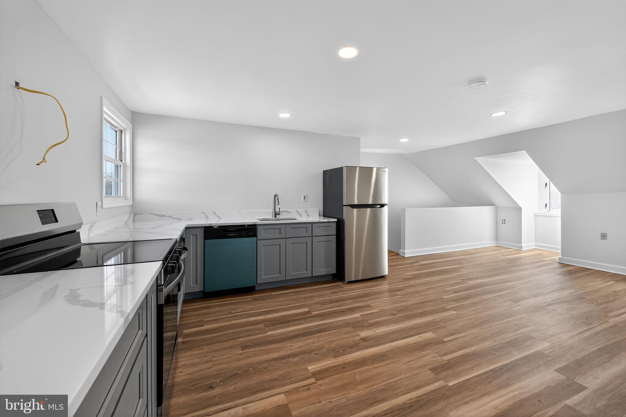 793 Penns Park Road, Unit C Newtown, PA 18940 - Photo 5 of 18 a kitchen with stainless steel appliances a refrigerator and a stove top oven