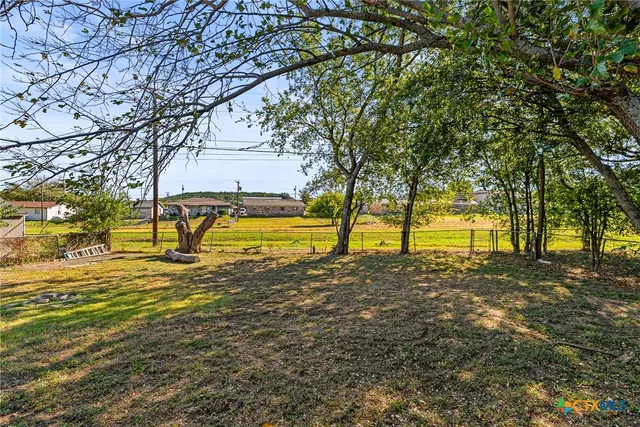 a view of a yard with swimming pool