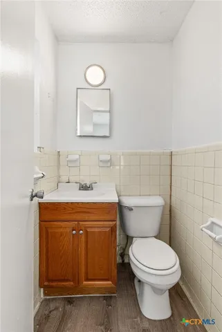 a bathroom with a toilet sink and mirror