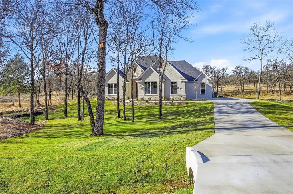 1053 Llano Way Poolville, TX 76487 - Photo 4 of 40 a view of a house with a yard