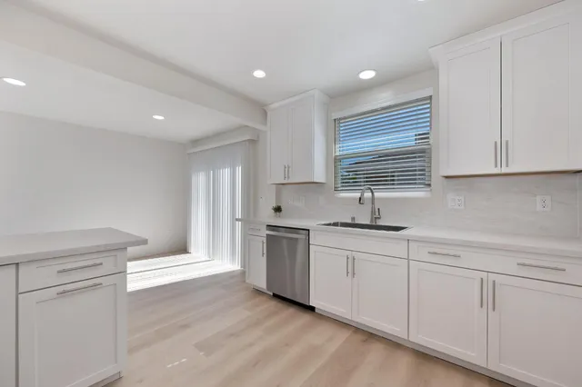 a kitchen with stainless steel appliances granite countertop a stove and a sink