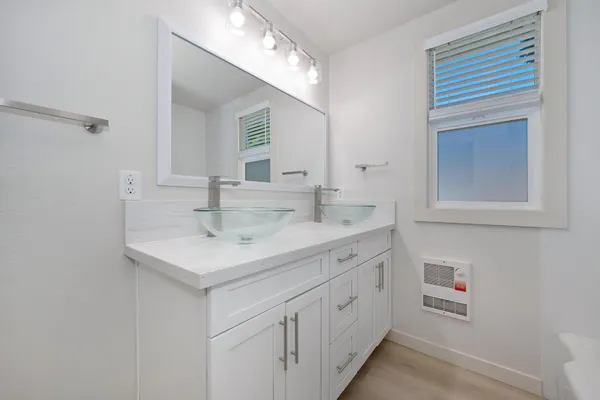 a white bath tub sitting next to a shower