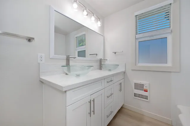 a white bath tub sitting next to a shower