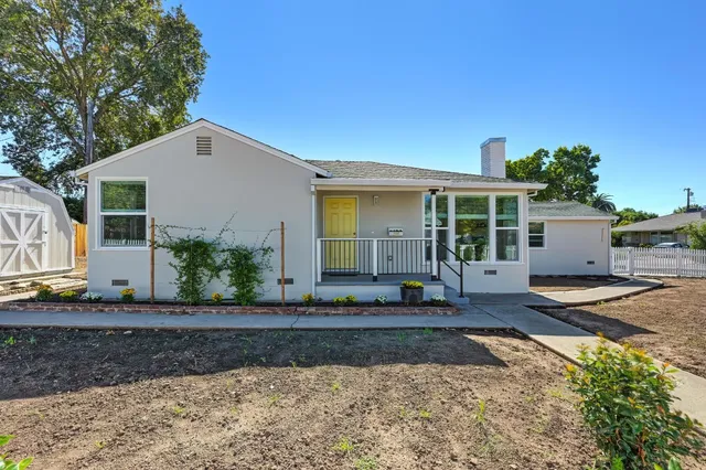 a front view of a house with garden