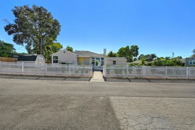 a view of a street with cars parked on road