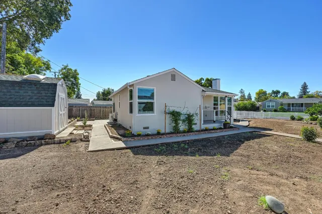 a view of an empty room and a kitchen