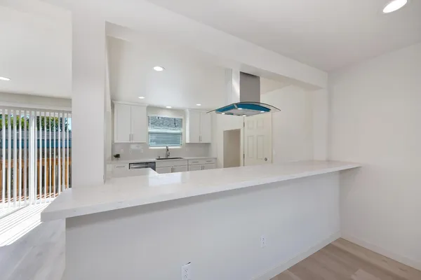 a view of wooden floor and windows in a room
