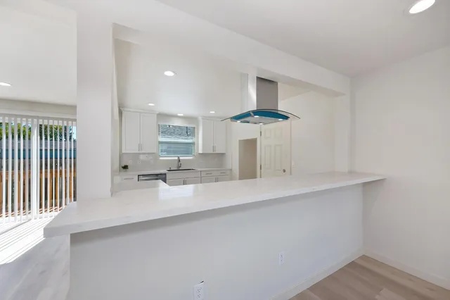 a view of wooden floor and windows in a room