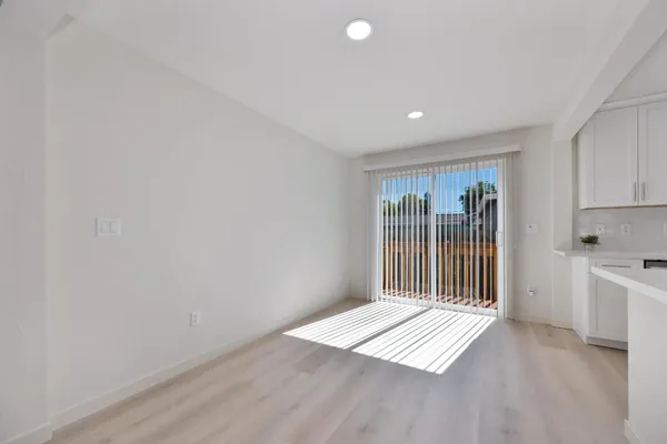 a kitchen with stainless steel appliances granite countertop a sink and cabinets with wooden floor