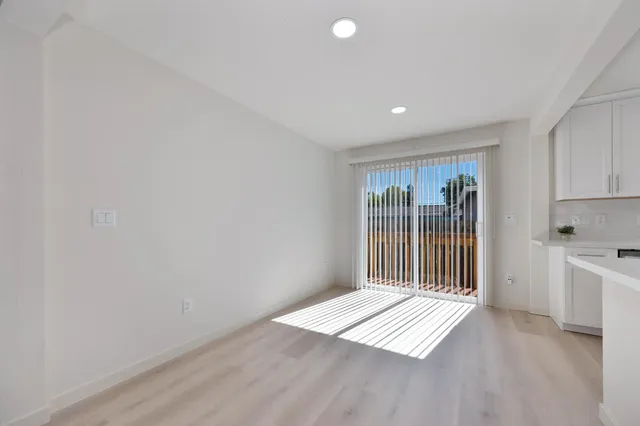 a kitchen with stainless steel appliances granite countertop a sink and cabinets with wooden floor