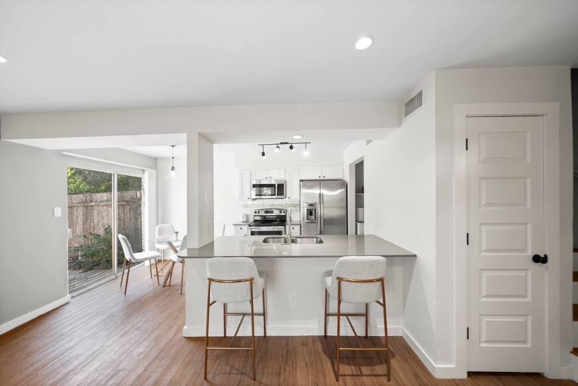 3507 Alpine Circle Austin, TX 78704 - Photo 3 of 39 a kitchen with stainless steel appliances kitchen island granite countertop a dining table chairs and granite counter tops