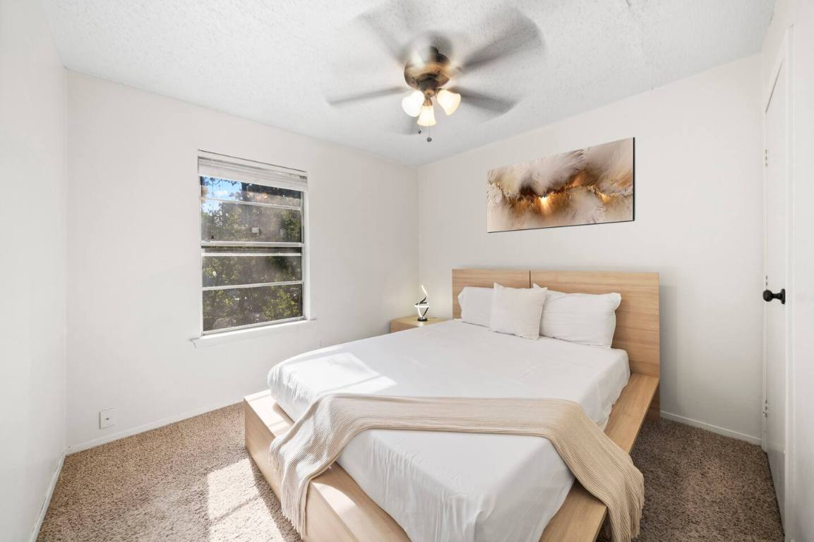 3507 Alpine Circle Austin, TX 78704 - Photo 6 of 39 a bedroom with a bed and a chandelier