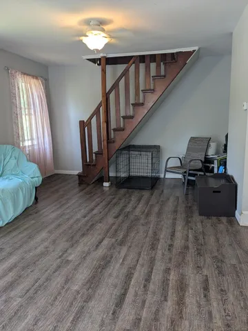 a view of entryway and hall with wooden floor