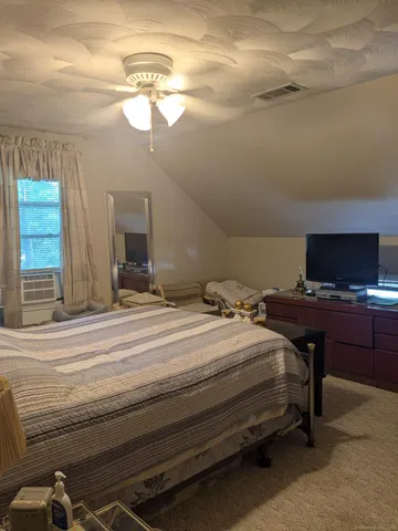 a bedroom with a bed and a mirror