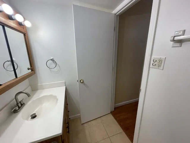 a bathroom with a sink and mirror