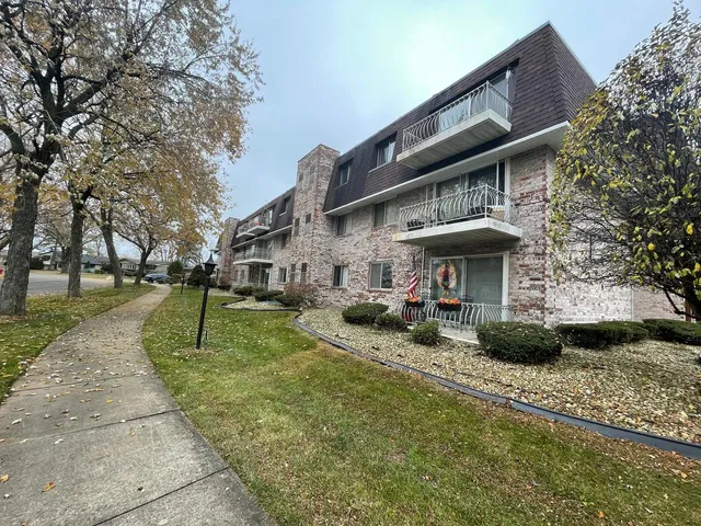 a view of a house with a yard patio and fire pit