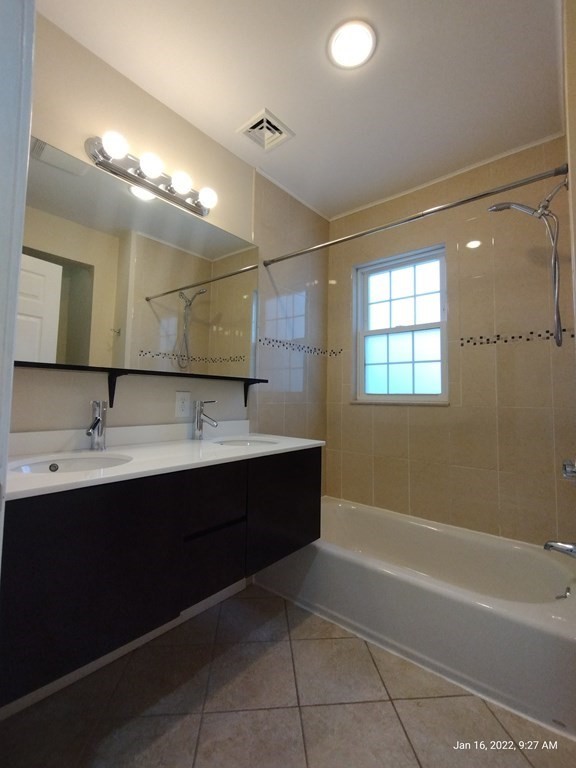 62 Washington Street, Unit 62 Wellesley, MA 02481 - Photo 10 of 18 a bathroom with a bathtub sink vanity and mirror