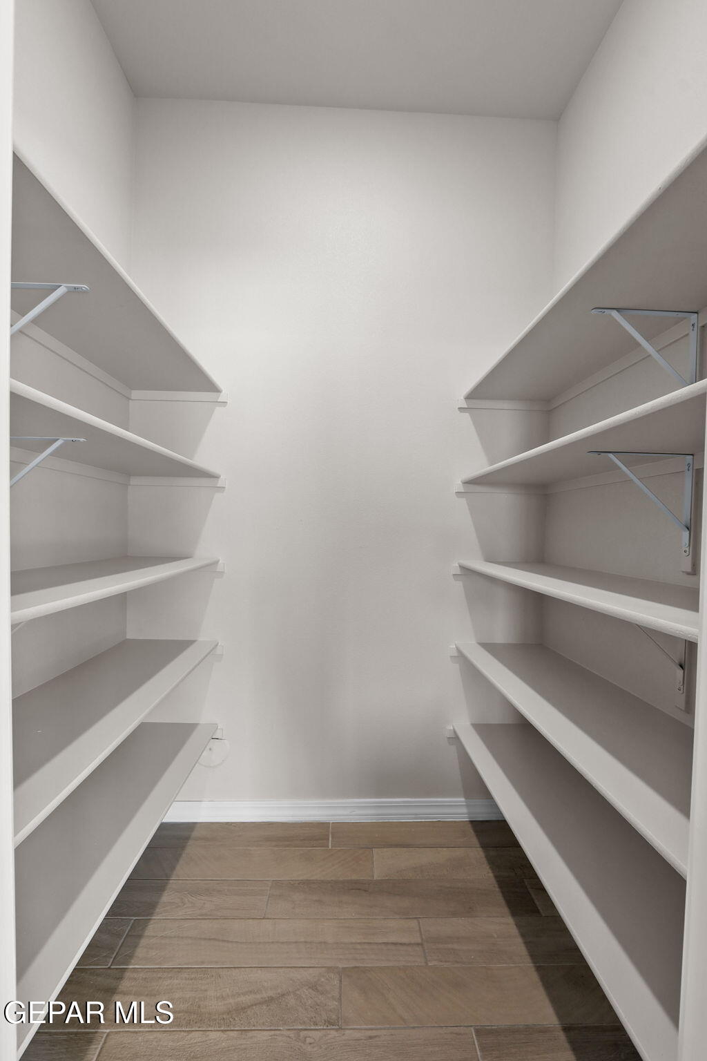 12420 Fill Ball El Paso, TX 79928 - Photo 32 of 47 a view of walk in closet with empty racks