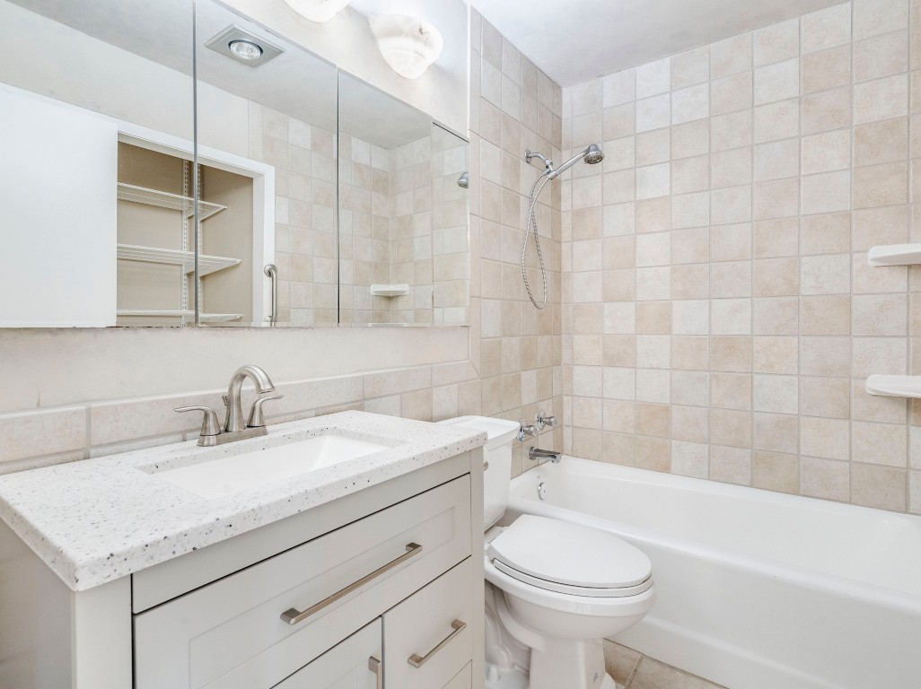 3815 Menchaca Road, Unit 19 Austin, TX 78704 - Photo 11 of 14 a bathroom with a sink toilet vanity and shower